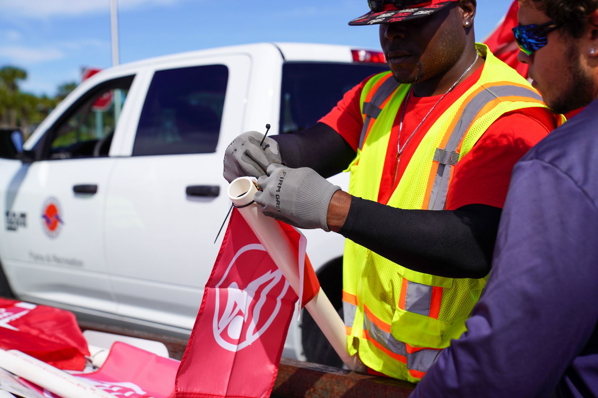Employee attaching beach flag